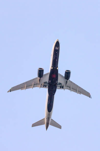 An Air Canada jet flying overhead on its approach to arrive at Pearson International Airport (YYZ) Toronto, Canada - May 5, 2023 : An Air Canada jet flying overhead on its approach to arrive at Pearson International Airport (YYZ) air canada airbus a320 stock pictures, royalty-free photos & images