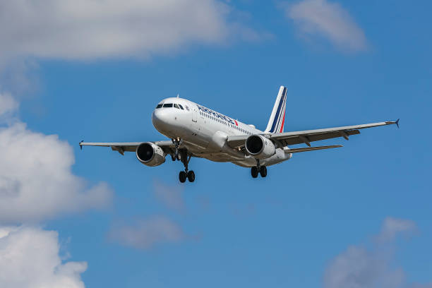 Air France Airbus A320 commercial jet aircraft as seen flying for landing at the runway of London Heathrow Airport in the summer blue sky. The...