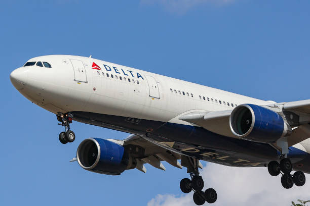 Delta Air Lines Airbus A330 aircraft as seen flying over Myrtle avenue during a summer day for landing at London Heathrow Airport LHR, a famous spot...