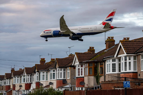 British Airways Boeing 787-8 Dreamliner aircraft spotted flying on final approach over the roofs of the houses of Myrtle avenue for landing at London...