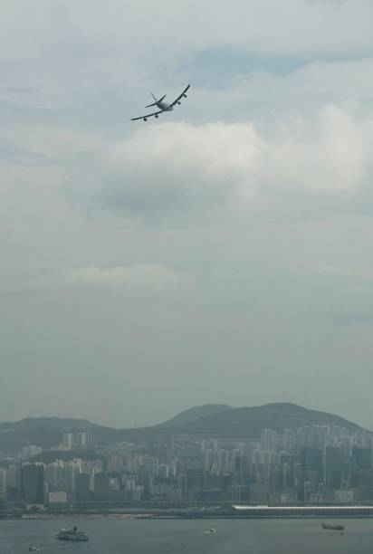 Cathay Pacific Boeing 747-400 aircraft, operating as flight CX8747, flies over Hong Kong's former Kai Tak airport on its final flight over Victoria...