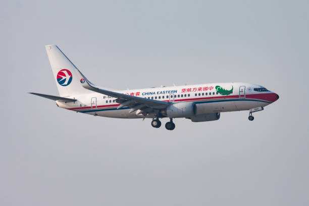 China Eastern Airlines passenger plane at airport. Schedule flight travel. Aviation and aircraft. Air transport. Global international transportation. Fly and flying. Hong Kong, China - November 16, 2013: China Eastern Airlines passenger plane at airport. Schedule flight travel. Aviation and aircraft. Air transport. Global international transportation. Fly and flying. china eastern airlines stock pictures, royalty-free photos & images