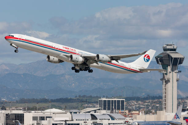 China Eastern Airlines Airbus A340 taking off from Los Angeles International Airport. Los Angeles, California, USA - March 10, 2010: China Eastern Airlines Airbus A340 airplane taking off from Los Angeles International Airport. china eastern airlines stock pictures, royalty-free photos & images