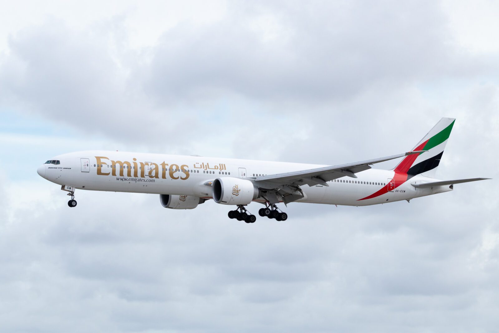 an emirates boeing 777-300 flying in the sky