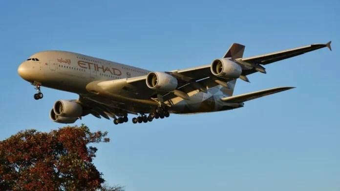 Etihad Airways Airbus A380-800 aircraft approaching for landing in golden evening light, part of airline's 7-aircraft superjumbo fleet serving premium routes to London Heathrow
