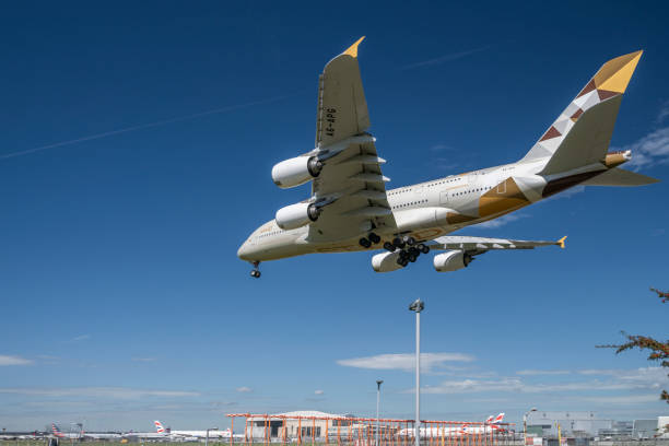 a low-flying etihad airways airbus a380 - etihad airways airbus a380 stock pictures, royalty-free photos & images