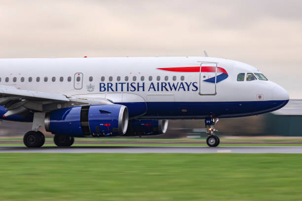 British Airways Airbus A319 passenger aircraft flying and landing at Polderbaan runway of Amsterdam Schiphol Airport EHAM AMS in the Netherlands. The...