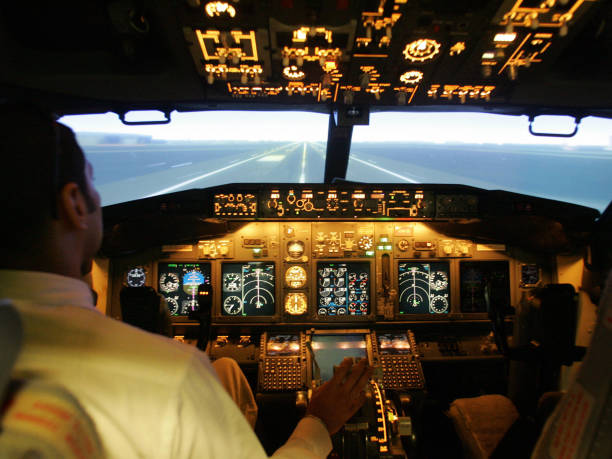 Flying instructor from Indian airline Jet Airways demonstrates a Full Flight Simulator for Boeing 737-800 aircraft in Mumbai, 22 November 2005. The...