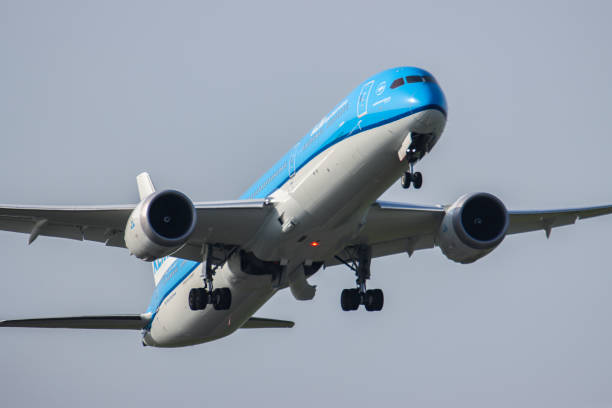 Royal Dutch Airlines Boeing 787-10 Dreamliner aircraft as seen during the takeoff and flying in the blue sky, departing from Amsterdam Schiphol AMS...
