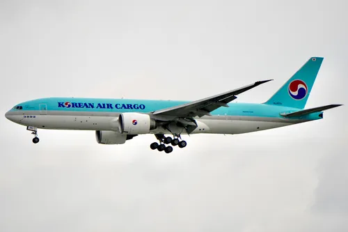 Free Korean Air Cargo Boeing 777 flying in the sky, showcasing aviation excellence. Stock Photo