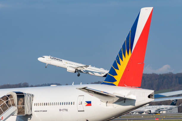 Lufthansa Airbus A321-231 jet and a Philippines Boeing 777-3F6-ER in Zurich in Switzerland Zurich, Switzerland, January 20,2023 Lufthansa Airbus A321-231 aircraft is taking off behind a Philippines Boeing 777-3F6-ER government plane lufthansa airbus a321 stock pictures, royalty-free photos & images