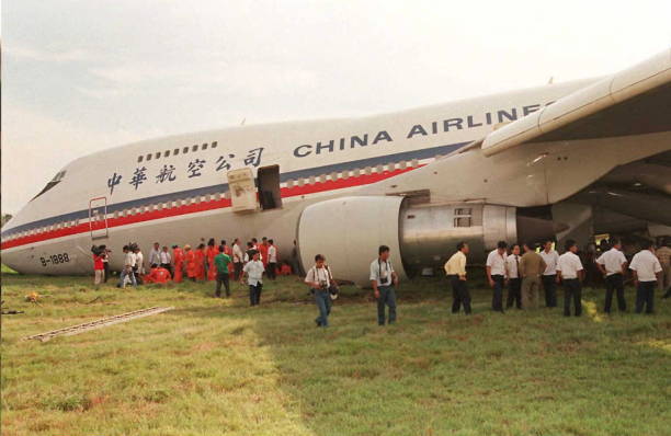 China Airlines Boeing 747 jet lay on its belly at the Manila airport after sliding nose-down several hundred meters after its front landing gears...