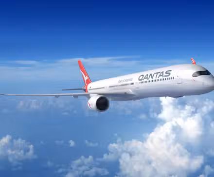 A Qantas Airbus A350 flying above the clouds.