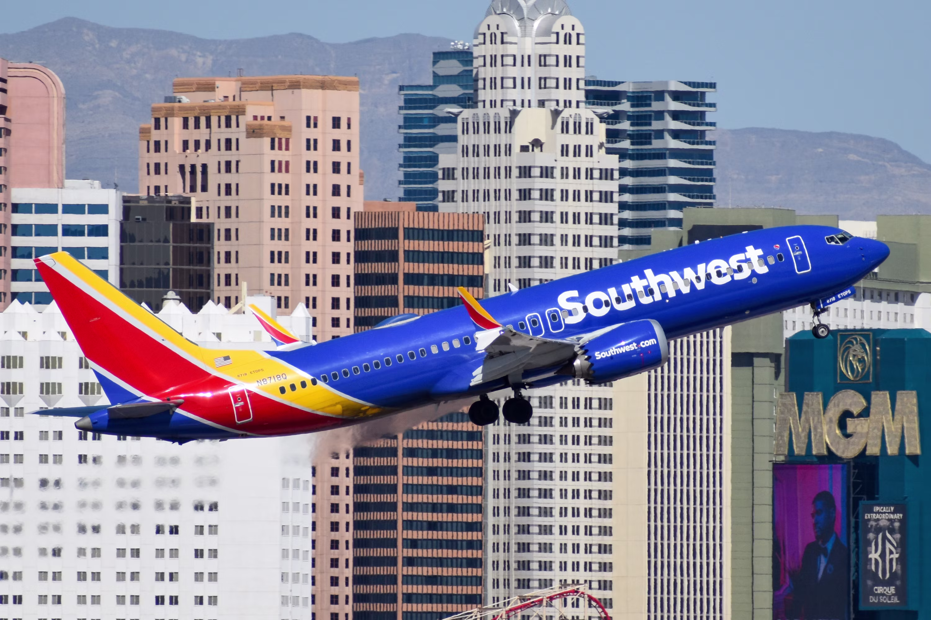 A southwest airlines jet flying over a city