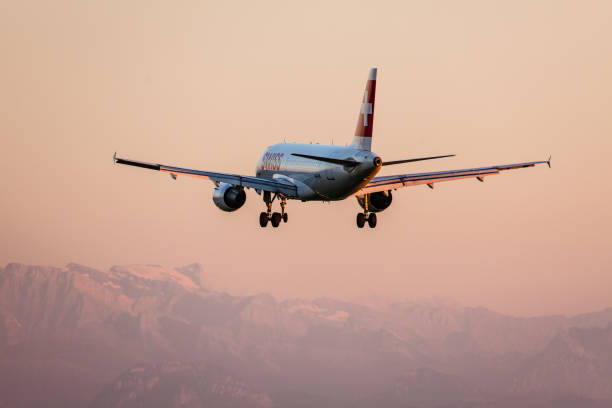 swiss international air lines airbus a318 landing in front of the swiss alps - airbus a340 stock pictures, royalty-free photos & images
