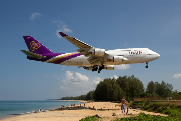Thai Airways Boeing 747-400 about to complete a domestic flight from Bangkok and landing at Phuket over Mai Khao beach.