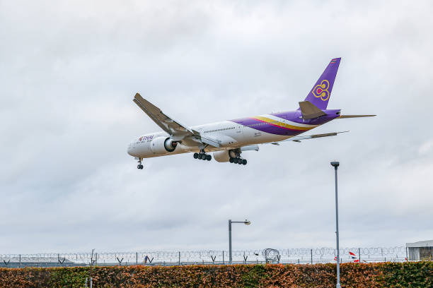 Thai Airways International Boeing 777 aircraft as seen on final approach flying over the houses of Myrtle avenue in London, for landing at London...
