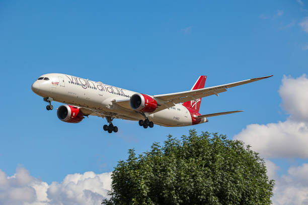 Virgin Atlantic Airways Boeing 787 Dreamliner as seen on final approach flying over the houses of Myrtle Avenue in London, a famous location for...