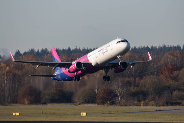 Wizz Air Airbus A321 aircraft as seen during taxiing, take off and flying phase departing from Eindhoven airport EIN during a blue sky sunny winter...