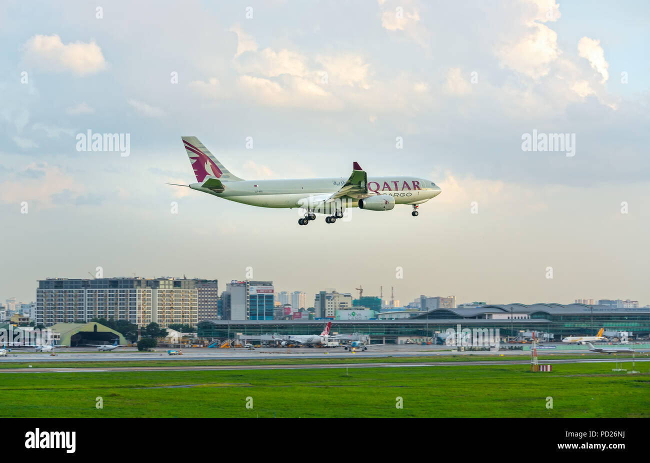 Airbus A330-200F Qatar Airways Cargo to fly over the clouds prepare landing Tan Son Nhat International Airport - Stock Image