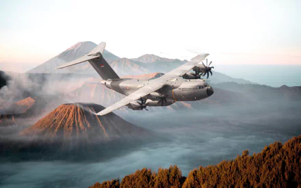 Military transport aircraft Airbus A400M flying over a volcanic landscape at sunrise — 4K Ultra HD PC desktop wallpaper background.