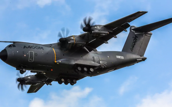 Airbus A400M military transport aircraft flying against a blue sky, captured in 4K Ultra HD quality for a desktop wallpaper background.