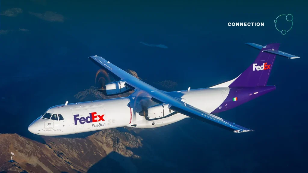 FedEx ATR72-600F freighter aircraft in flight with distinctive purple and white FedEx livery flying over mountainous terrain
