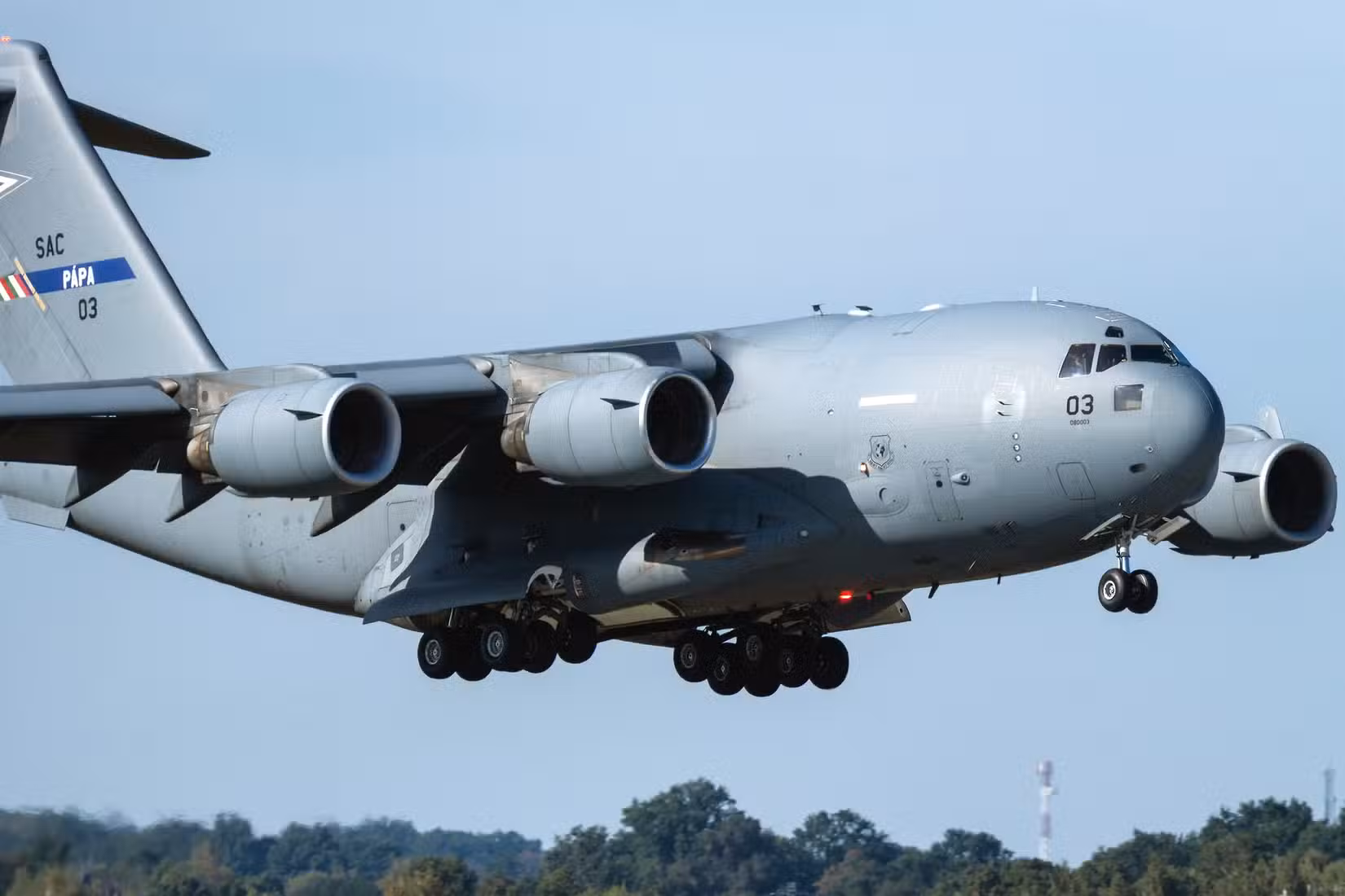 A Boeing C-17 Globemaster III flying low to the ground