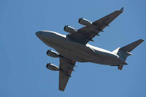 C-17 “Globemaster III” In Flight "Hillsboro, United States- August 4, 2012:  The Oregon International Airshow is a 3 day event in Hillsboro, Oregon. This image shows a C-17 Globemaster III cargo plane in flight over the show." c 17 globemaster stock pictures, royalty-free photos & images