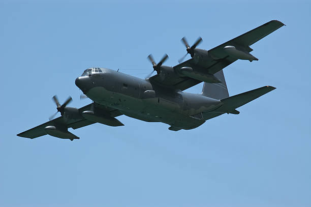 Lockheed C-130 Hercules flying in clear blue sky US Air Force transport aeroplane c 130 hercules stock pictures, royalty-free photos & images