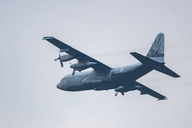 lockheed c-130 hercules military airplane flying in mid air during sunset - c130 plane stock pictures, royalty-free photos & images