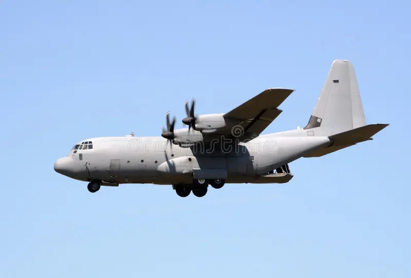 Grey military C-130J Hercules flying by with open cargo door. C130 stock images, royalty-free photos and pictures