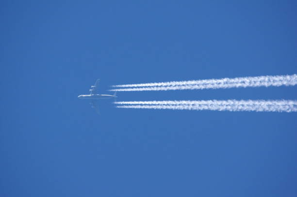 High flying Lockheed C-5 Galaxy  with condensation trail, chem trails High flying Lockheed C-5 Galaxy military Cargo plain  with condensation trail, chem trails, above the netherlands, march 2023, c 5 galaxy stock pictures, royalty-free photos & images