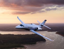 Cessna Citation Latitude jet flying above the clouds during daytime
