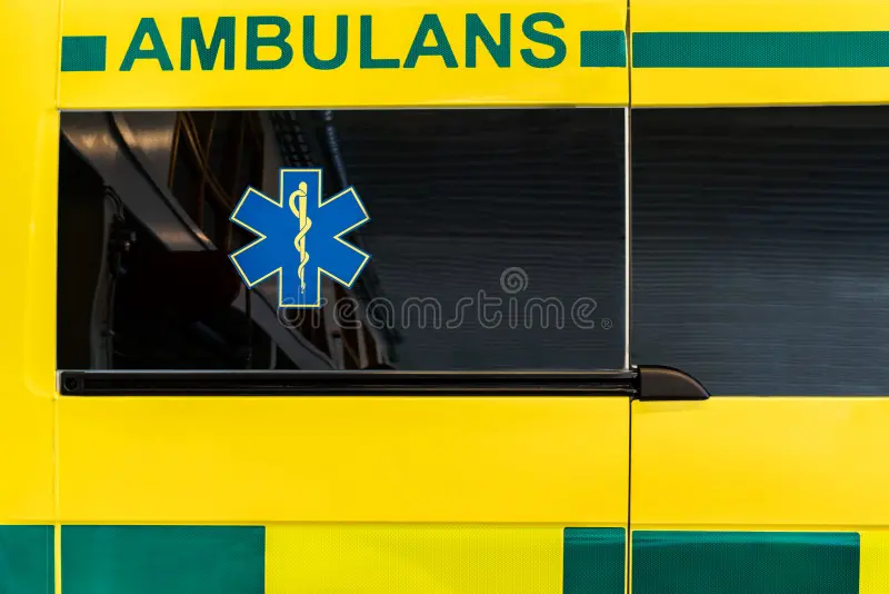 Close up side view of a yellow and green Swedish ambulance vehicle. Horizontal composition. Ambulance car side view stock images, royalty-free photos and pictures