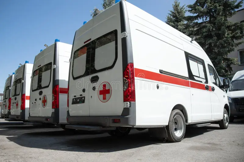 A row of rescuers cars. Side view of an ambulances standing in parking. Medicine concept. Back side ambulance stock images, royalty-free photos and pictures