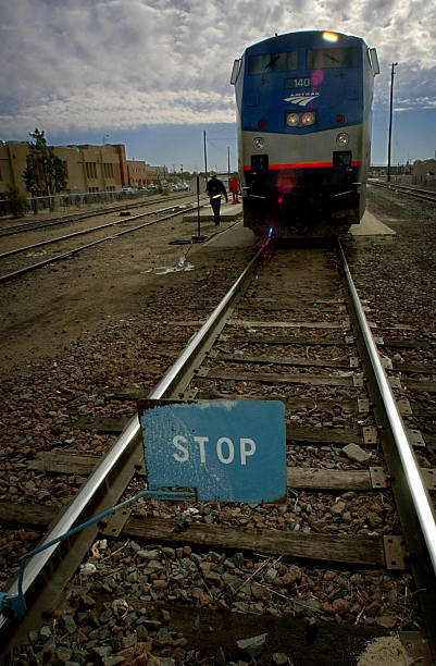 Stop sign sits on the rails in front of an Amtrak Superliner train heading for Chicago. Because Amtrak doesn't own the rails, trains often have to...