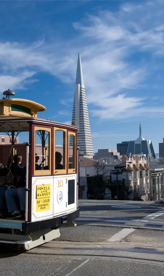 A San Francisco cablecar, with the Transamerica building and Chinatown in the background.