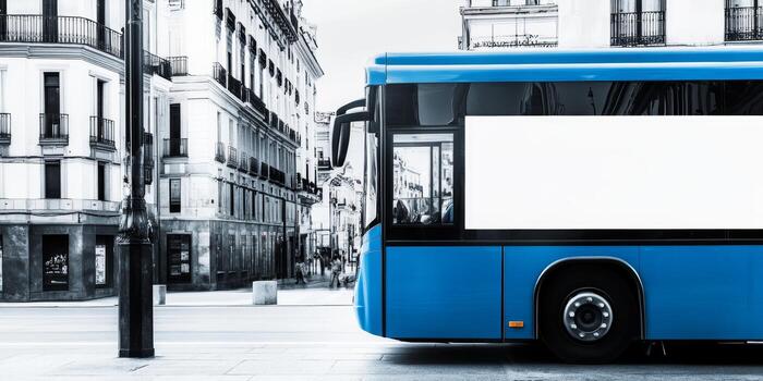 Blue city bus parked on a street in an urban area during daylight hours photo
