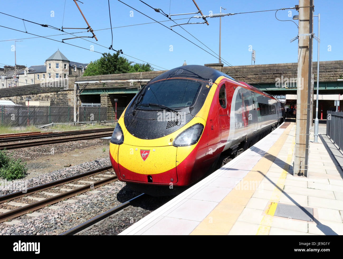 Class 390 Pendolino electric multiple unit in Virgin Trains (West Coast) livery at platform 4 at Lancaster railway - Stock Image
