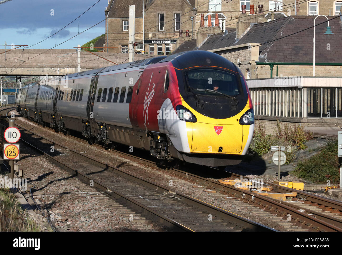 Class 390 Pendolino electric multiple unit train passing through Carnforth on the West Coast Main line on Monday 24th September 2018. - Stock Image