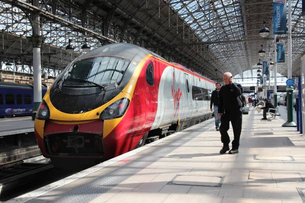 Virgin Trains People exit Virgin Trains Pendolino train in Manchester, UK. Virgin Trains operates since 1997 and as of 2013 uses 56 Class 390 Pendolino train sets. pendolino train stock pictures, royalty-free photos & images