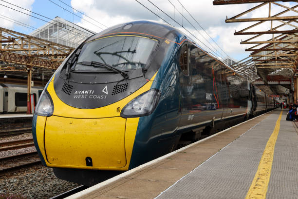 Avanti West Coast Pendolino Passenger Train at Crewe Railway Station Avanti West Coast Pendolino Passenger Train at Crewe Railway Station passengers can be seen on the platform and another train under. pendolino train stock pictures, royalty-free photos & images