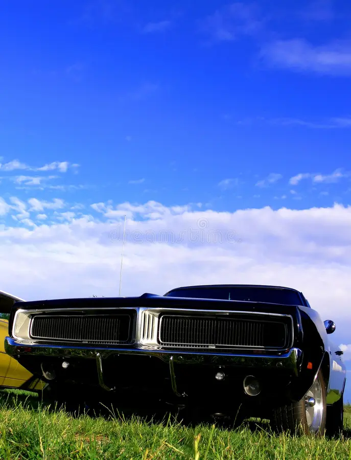 A black american classic muscle car from the late 1960s parked on grass. Classic muscle cars stock images, royalty-free photos and pictures