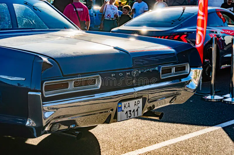 Black and white classic muscle car, possibly a Pontiac model from mid-20th century, on display at an outdoor auto show or similar event Well-maintained with hood sc Kyiv, Ukraine - September 21, 2025. Classic muscle cars stock images, royalty-free photos and pictures
