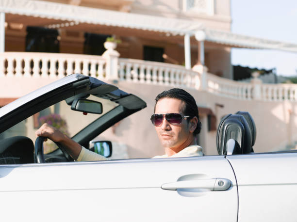 man driving convertible - convertible car side view stock pictures, royalty-free photos & images