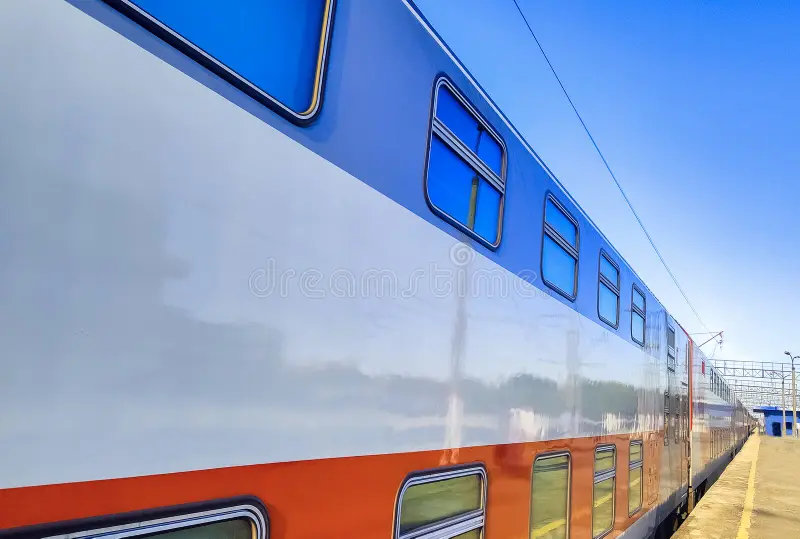 Side of a double-decker train leaving a station stock photos