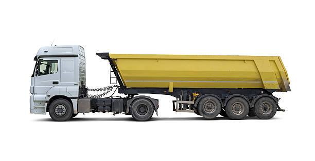Dump Truck Side view of semi-trailer dump truck. Isolated on white background. dump truck side view stock pictures, royalty-free photos & images