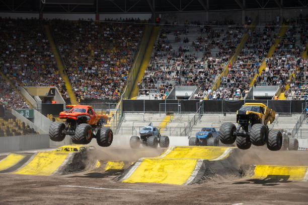 July 2023, Saxony, Dresden: : The monster truck "EL TORO LOCO" with driver Brandon Arthur and "EARTHSHAKER" with driver Tony Ochs jump over ramps at...
