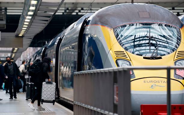 Passengers board a Eurostar train at St Pancras International station in London on December 23 as services prepare to resume following a 48 hour...